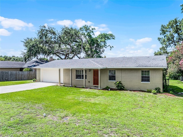 1011 W 13th St, Lakeland, FL 33805 - ranch-style home with driveway, a garage, brick siding, a chimney, and roof with shingles