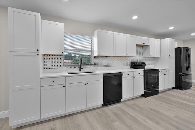 1011 W 13th St, Lakeland, FL 33805 - kitchen featuring black appliances, light countertops, light wood-style floors, tasteful backsplash, and recessed lighting