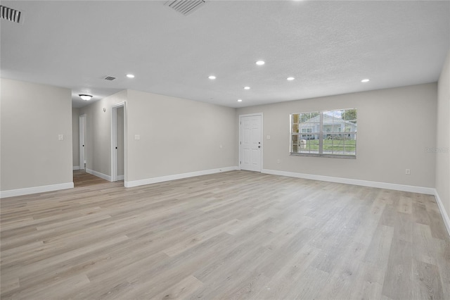 1011 W 13th St, Lakeland, FL 33805 - unfurnished living room featuring recessed lighting and light wood finished floors