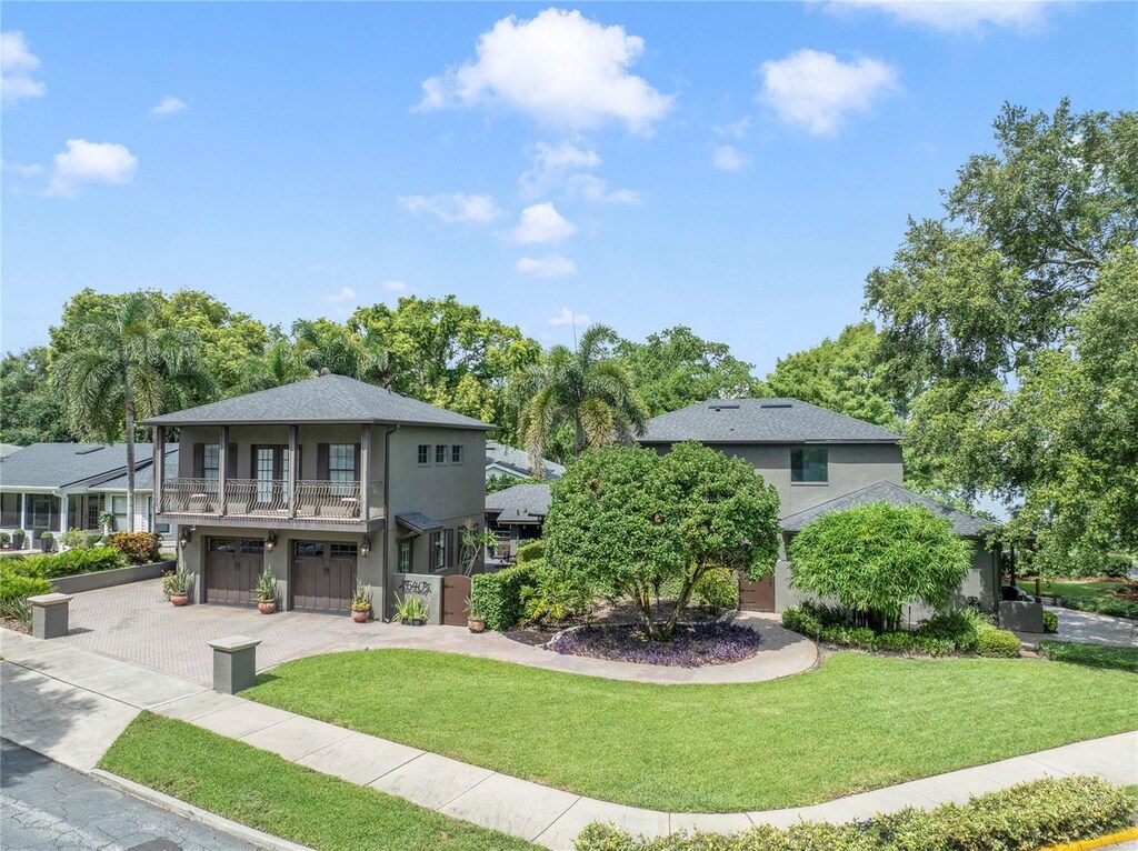 640 S Lake Formosa Dr, Orlando, FL 32803 - view of front of home with a garage, a balcony, stucco siding, and driveway