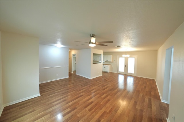 5472 E Grant St, Orlando, FL 32812 - unfurnished living room with wood finished floors, ceiling fan, and a chandelier
