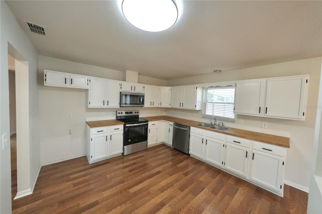 5472 E Grant St, Orlando, FL 32812 - kitchen featuring appliances with stainless steel finishes, wood counters, and white cabinets