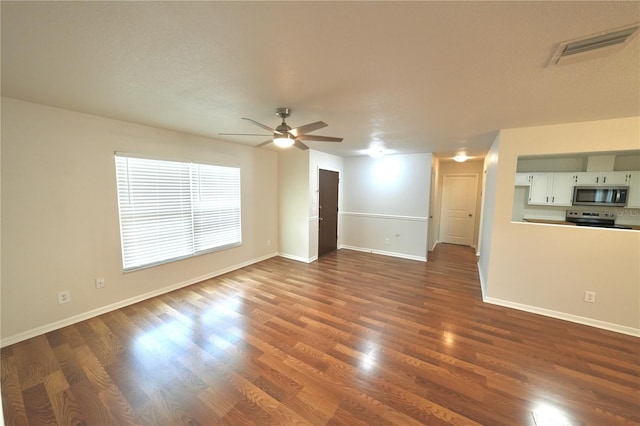 5472 E Grant St, Orlando, FL 32812 - unfurnished living room with dark wood-style flooring and a ceiling fan