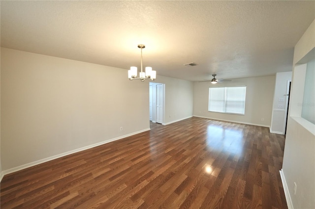 5472 E Grant St, Orlando, FL 32812 - spare room with a chandelier, a ceiling fan, dark wood-style flooring, and a textured ceiling