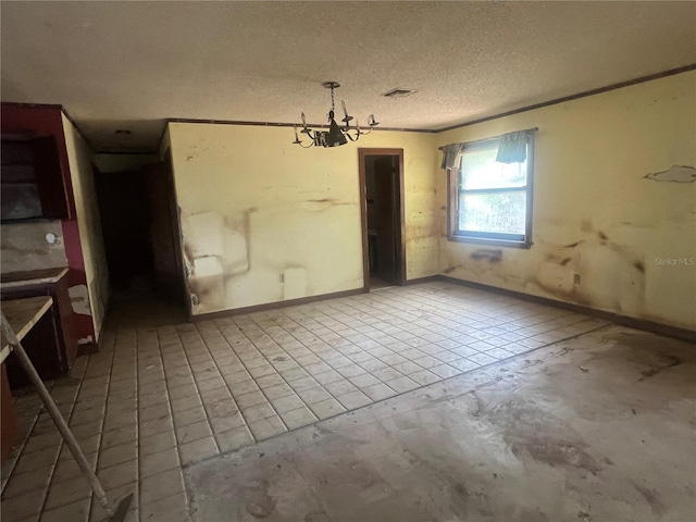 unfurnished dining area with a chandelier and a textured ceiling
