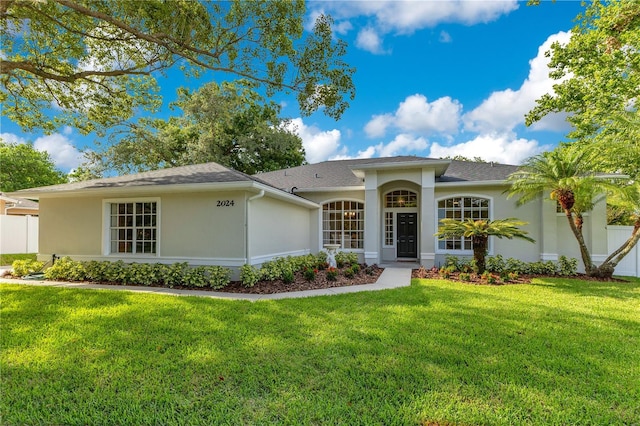 2024 Flaming Arrow Ct, Fern Park, FL 32730 - ranch-style home with stucco siding, a front lawn, and a shingled roof