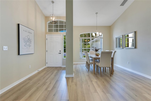 2024 Flaming Arrow Ct, Fern Park, FL 32730 - dining area with a towering ceiling, a chandelier, and light wood-style flooring