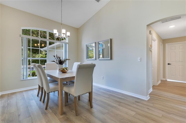 2024 Flaming Arrow Ct, Fern Park, FL 32730 - dining space featuring arched walkways, light wood-type flooring, a chandelier, and high vaulted ceiling