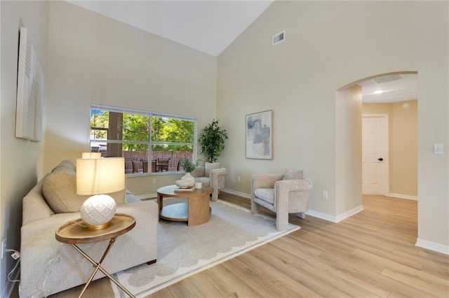 2024 Flaming Arrow Ct, Fern Park, FL 32730 - living room with high vaulted ceiling, arched walkways, and wood finished floors