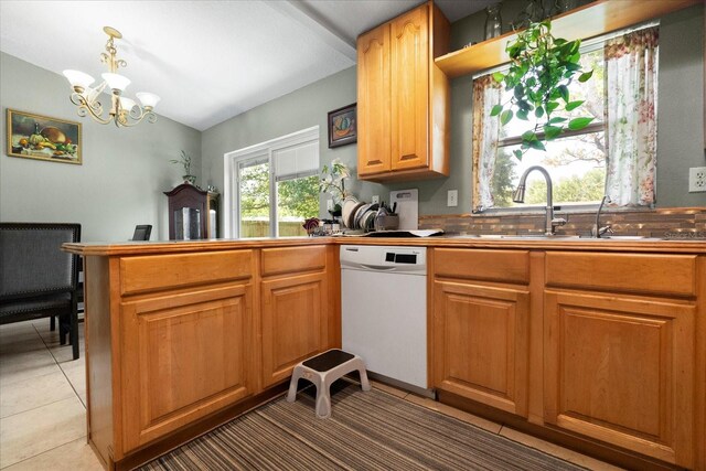 303 Mariana Way, Kissimmee, FL 34758 - kitchen featuring white dishwasher, a peninsula, a chandelier, vaulted ceiling, and light tile patterned floors