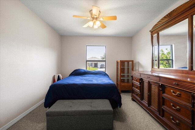 303 Mariana Way, Kissimmee, FL 34758 - bedroom with light colored carpet, multiple windows, and ceiling fan