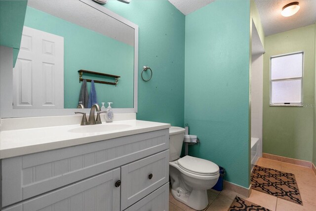 303 Mariana Way, Kissimmee, FL 34758 - full bathroom with vanity, tile patterned floors, and a textured ceiling
