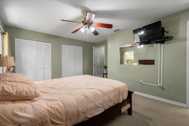 303 Mariana Way, Kissimmee, FL 34758 - bedroom featuring carpet floors, multiple closets, and ceiling fan