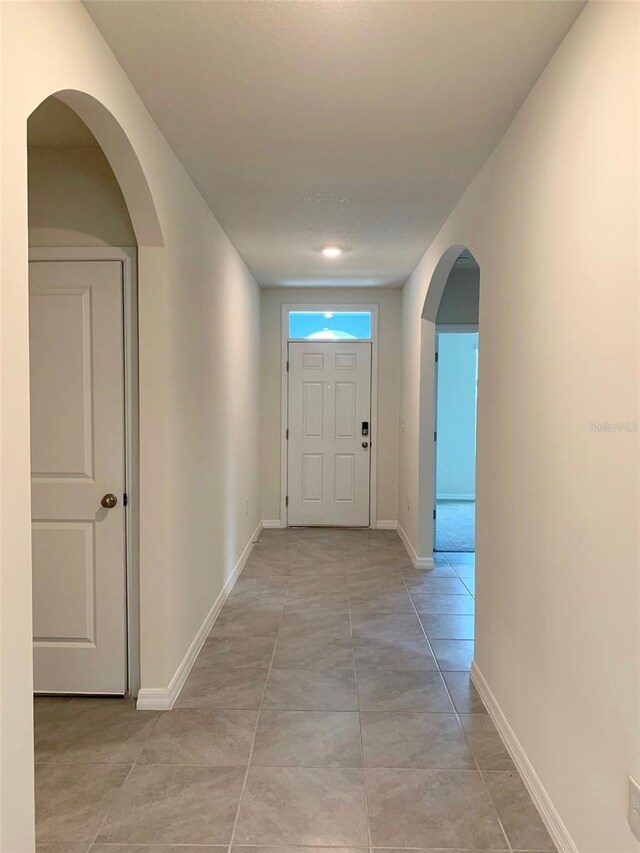613 Hickory Course Loop, Ocala, FL 34472 - corridor with arched walkways and light tile patterned flooring