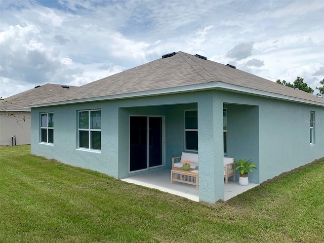 613 Hickory Course Loop, Ocala, FL 34472 - back of property featuring a patio area, a yard, stucco siding, and a shingled roof