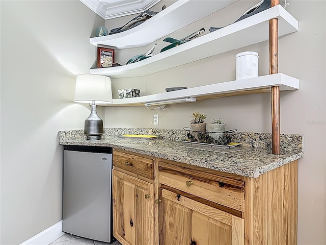 2055 S Atlantic Ave Unit 1410, Daytona Beach Shores, FL 32118 - kitchen with open shelves, freestanding refrigerator, light stone countertops, crown molding, and light tile patterned floors