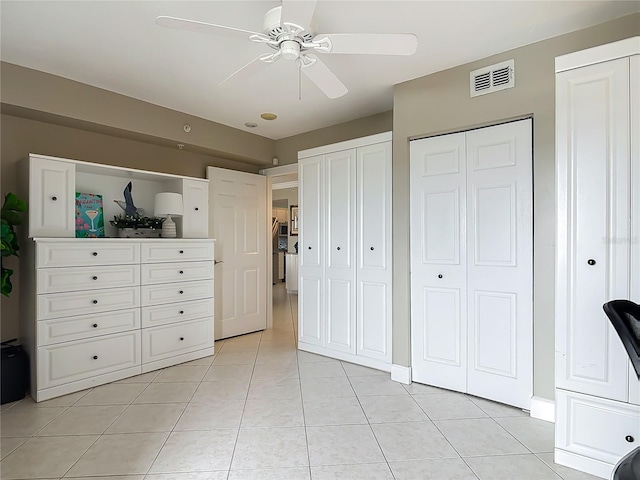 2055 S Atlantic Ave Unit 1410, Daytona Beach Shores, FL 32118 - bedroom with light tile patterned floors, multiple closets, and ceiling fan