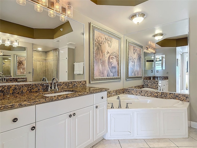 2055 S Atlantic Ave Unit 1410, Daytona Beach Shores, FL 32118 - bathroom featuring a stall shower, a garden tub, vanity, and tile patterned floors
