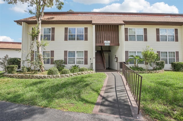 2400 Forest Dr Unit 219, Inverness, FL 34453 - townhome / multi-family property featuring a front lawn and roof with shingles