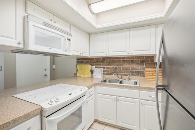 2400 Forest Dr Unit 219, Inverness, FL 34453 - kitchen with white appliances, light countertops, decorative backsplash, and white cabinets