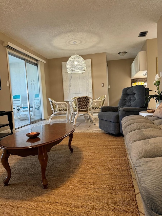 2400 Forest Dr Unit 219, Inverness, FL 34453 - living room with a textured ceiling and light tile patterned flooring