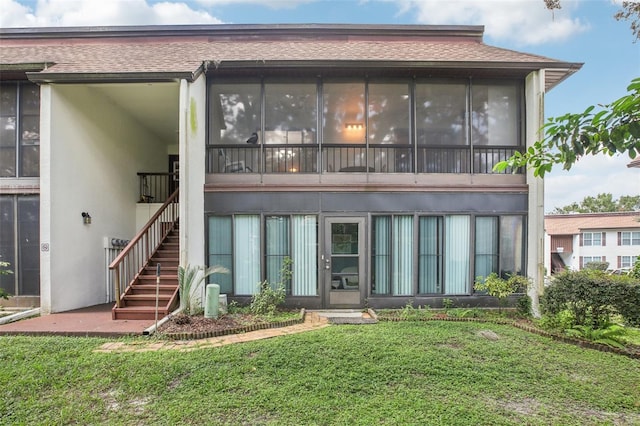 2400 Forest Dr Unit 219, Inverness, FL 34453 - rear view of property with stairway, stucco siding, a yard, and a shingled roof
