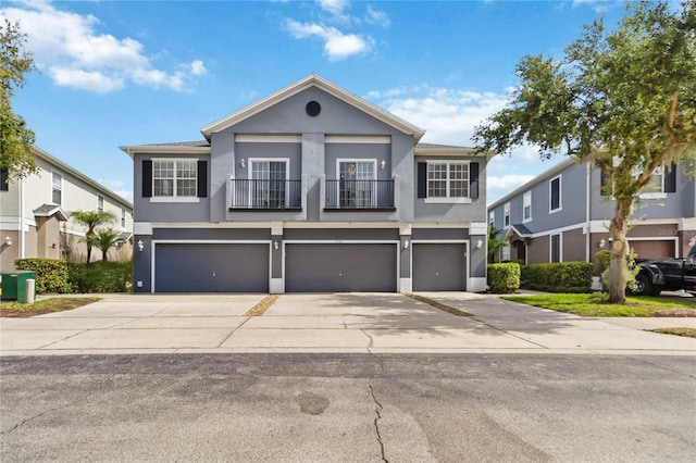 6484 S Goldenrod Rd Unit 41A, Orlando, FL 32822 - view of front of property featuring a balcony, stucco siding, a garage, and driveway