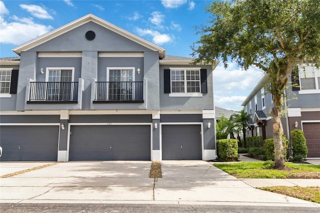 6484 S Goldenrod Rd Unit 41A, Orlando, FL 32822 - multi unit property featuring a balcony, stucco siding, concrete driveway, and a garage