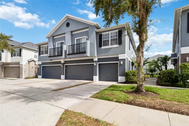 6484 S Goldenrod Rd Unit 41A, Orlando, FL 32822 - townhome / multi-family property featuring stucco siding, an attached garage, concrete driveway, and a balcony