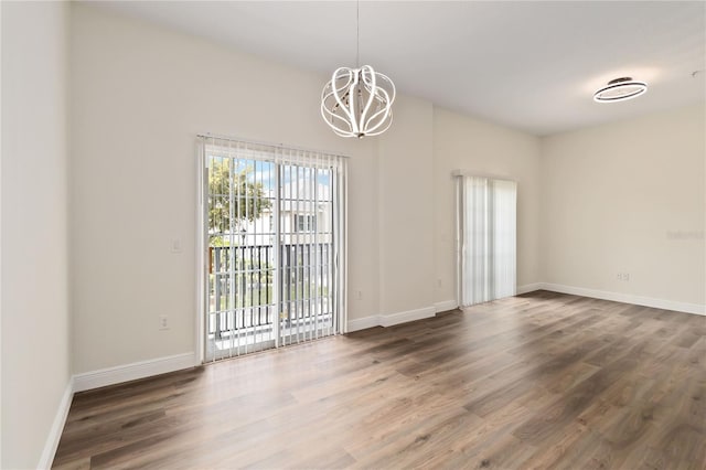 6484 S Goldenrod Rd Unit 41A, Orlando, FL 32822 - empty room with a chandelier and wood finished floors
