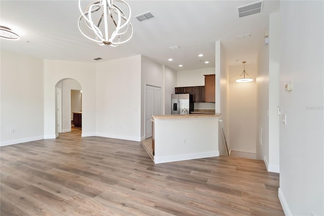 6484 S Goldenrod Rd Unit 41A, Orlando, FL 32822 - kitchen with stainless steel fridge, arched walkways, open floor plan, light wood-type flooring, and recessed lighting