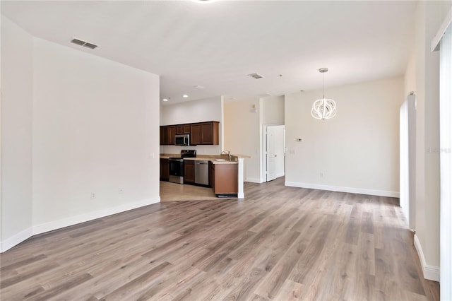 6484 S Goldenrod Rd Unit 41A, Orlando, FL 32822 - unfurnished living room with light wood-style floors, recessed lighting, and a chandelier
