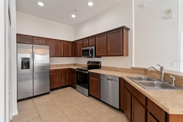 6484 S Goldenrod Rd Unit 41A, Orlando, FL 32822 - kitchen with stainless steel appliances, light tile patterned floors, light countertops, recessed lighting, and a peninsula