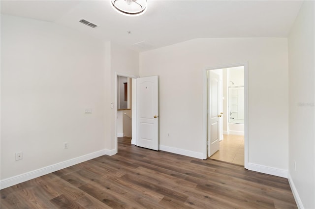 6484 S Goldenrod Rd Unit 41A, Orlando, FL 32822 - unfurnished bedroom featuring lofted ceiling, wood finished floors, and ensuite bath