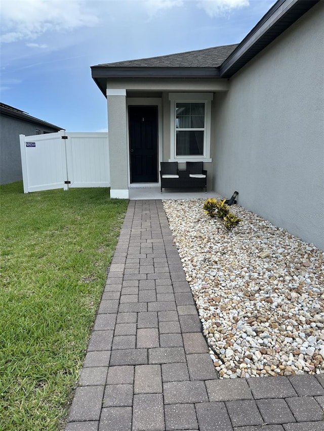 2824 Neverland Dr, New Smyrna Beach, FL 32168 - property entrance with stucco siding and roof with shingles
