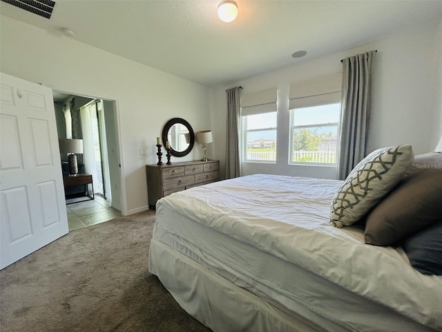 2824 Neverland Dr, New Smyrna Beach, FL 32168 - carpeted bedroom featuring baseboards and tile patterned floors
