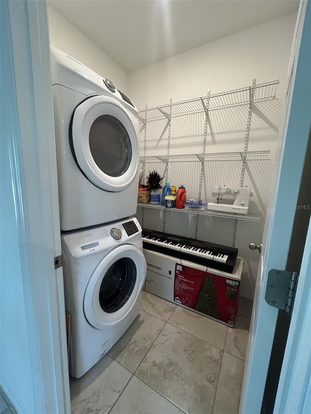 2824 Neverland Dr, New Smyrna Beach, FL 32168 - laundry room with stacked washer and clothes dryer and marble look tiles