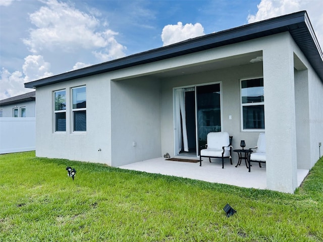 2824 Neverland Dr, New Smyrna Beach, FL 32168 - back of house featuring a patio and stucco siding