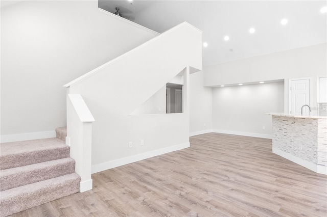 6384 Raleigh St Unit 2214, Orlando, FL 32835 - unfurnished living room featuring stairs, wood finished floors, and recessed lighting
