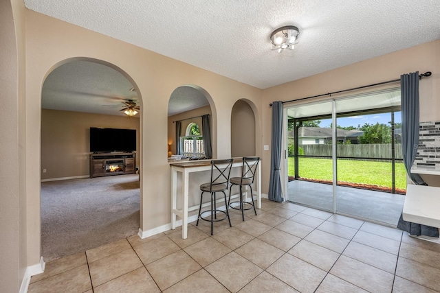 100 Monterey Oaks Dr, Sanford, FL 32771 - kitchen with a textured ceiling, ceiling fan, light tile patterned floors, and arched walkways