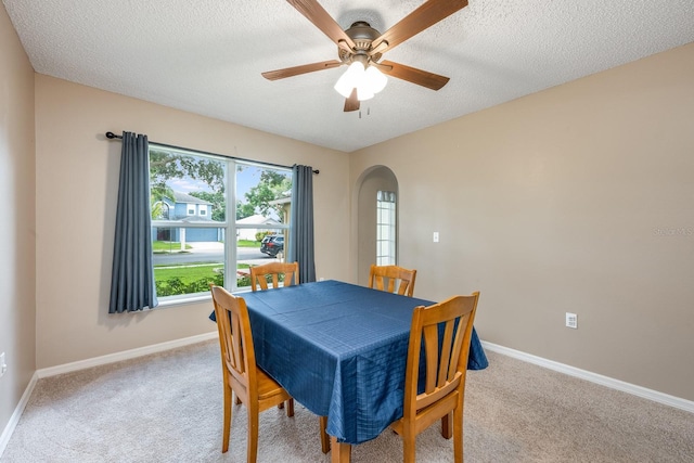 100 Monterey Oaks Dr, Sanford, FL 32771 - dining space with arched walkways, carpet, a ceiling fan, and a textured ceiling