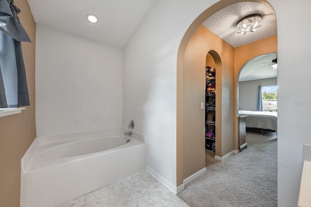 100 Monterey Oaks Dr, Sanford, FL 32771 - bathroom with a textured ceiling, a garden tub, and a ceiling fan