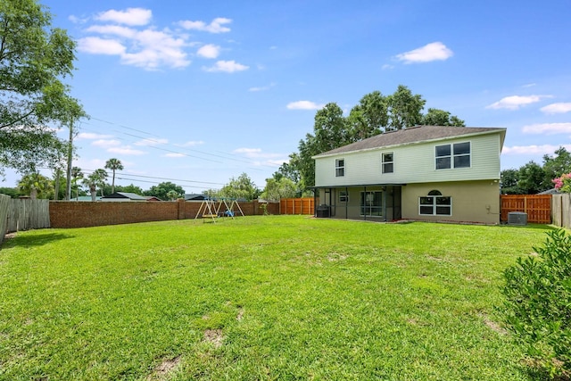 100 Monterey Oaks Dr, Sanford, FL 32771 - back of property featuring a playground, a sunroom, and a fenced backyard