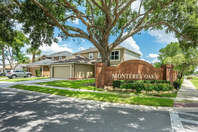 100 Monterey Oaks Dr, Sanford, FL 32771 - community sign featuring a garage and driveway