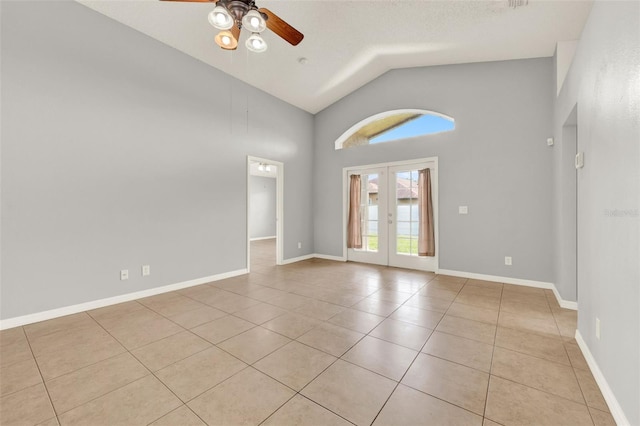 2713 Eagle Glen Cir, Kissimmee, FL 34746 - empty room featuring ceiling fan, light tile patterned floors, high vaulted ceiling, and french doors