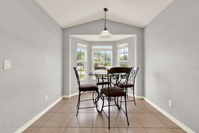 2713 Eagle Glen Cir, Kissimmee, FL 34746 - dining space with vaulted ceiling, light tile patterned floors, and a textured ceiling