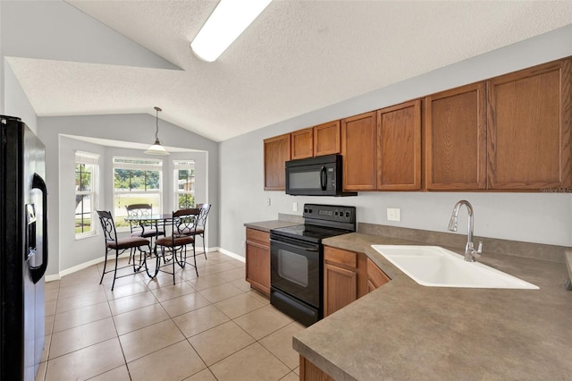 2713 Eagle Glen Cir, Kissimmee, FL 34746 - kitchen with black appliances, brown cabinets, lofted ceiling, a textured ceiling, and light tile patterned floors