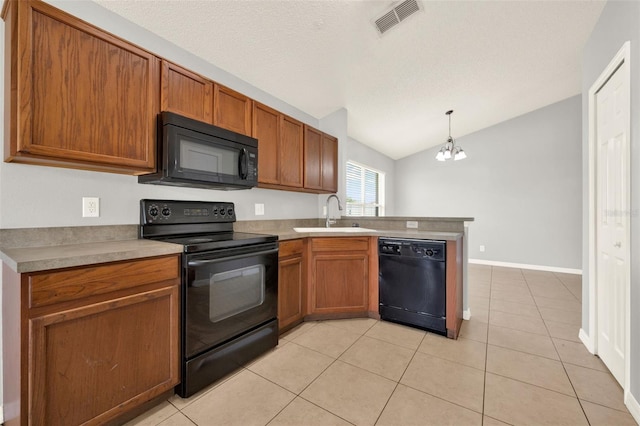 2713 Eagle Glen Cir, Kissimmee, FL 34746 - kitchen with black appliances, a peninsula, lofted ceiling, light tile patterned floors, and brown cabinets