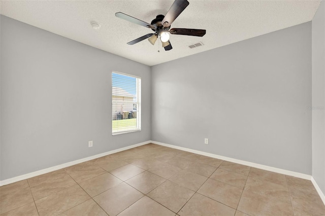 2713 Eagle Glen Cir, Kissimmee, FL 34746 - empty room with ceiling fan, a textured ceiling, light tile patterned floors, and a smoke detector