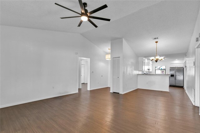845 Valnera Ct, Kissimmee, FL 34758 - unfurnished living room with a chandelier, ceiling fan, vaulted ceiling, and dark wood-style floors